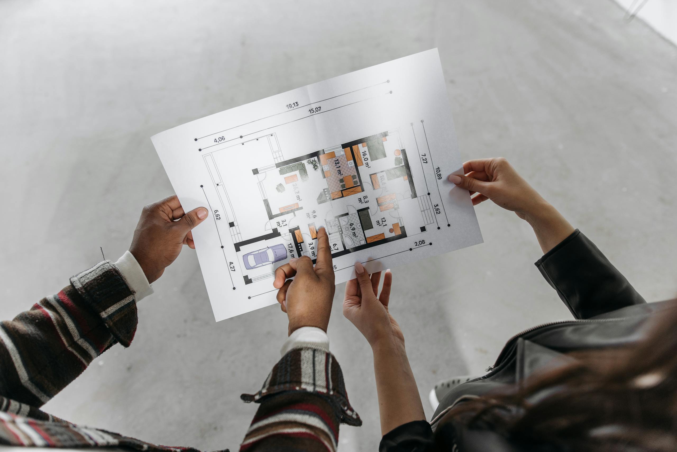 Couple Holding Blueprint of a House